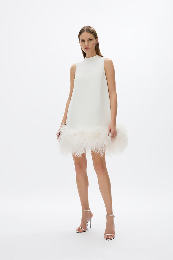 Linc Mini: chic white A-line mini dress featuring a voluminous feather hem for a playful touch.