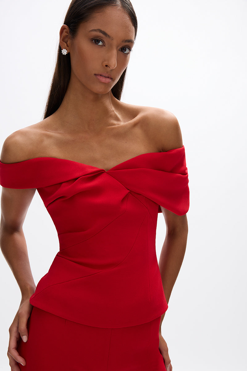 Mattie Top: sleek red fitted top with off-the-shoulder detail, designed for a flattering fit and versatile styling.