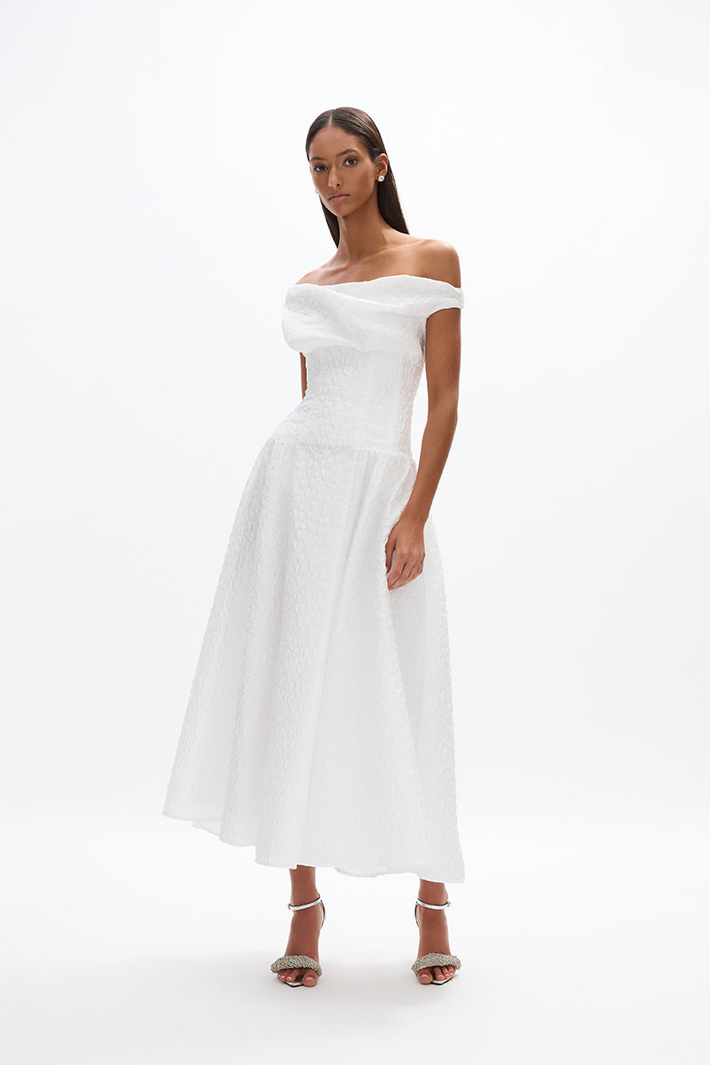 Elley Dress: elegant white mid-length dress with off-the-shoulder detail and a fitted waist, ideal for day events. 