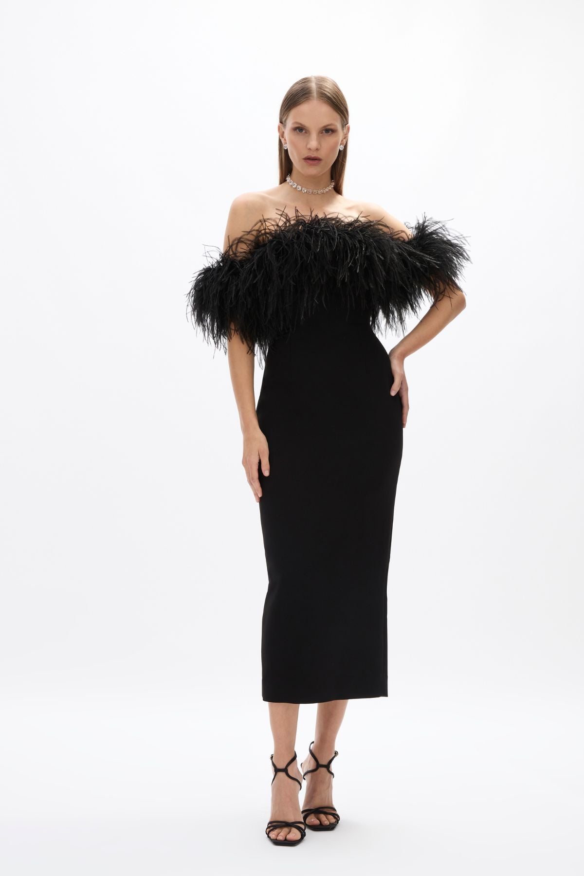 Link Dress: elegant mid-length black dress featuring feather detail and back split, perfect for cocktail events.